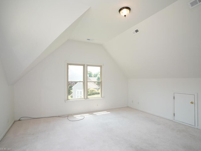 bonus room featuring lofted ceiling and light carpet