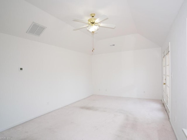 carpeted empty room featuring ceiling fan and vaulted ceiling