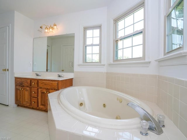 bathroom with vanity and tiled tub