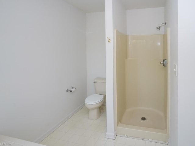 bathroom featuring toilet and walk in shower