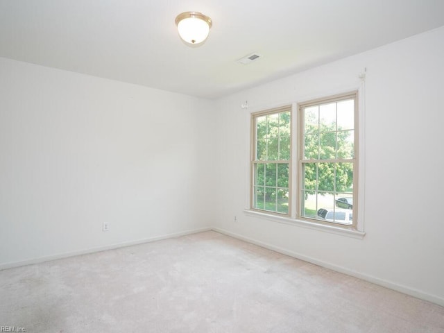 spare room with light carpet