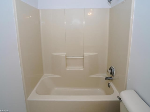 bathroom with shower / tub combination and toilet