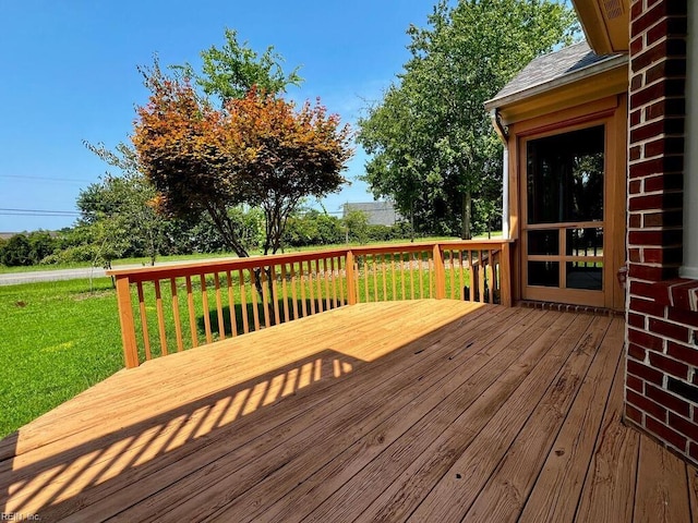 wooden deck with a lawn