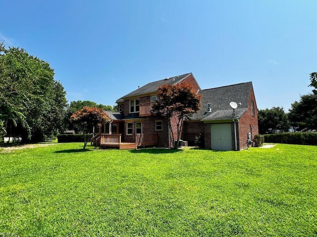 rear view of house with a yard and a deck