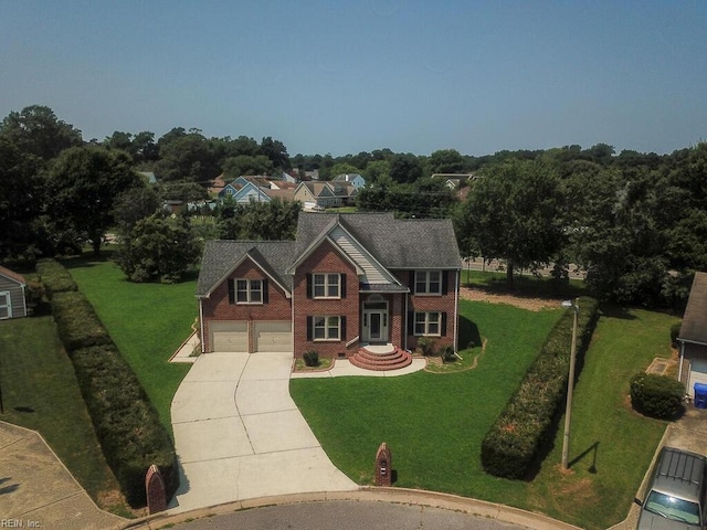 view of front of property with a garage and a front yard