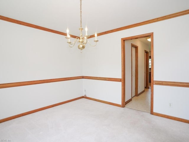 empty room featuring light carpet, a notable chandelier, and crown molding