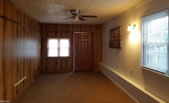 8530 Orcutt Ave, Hampton, VA 23605 - carpeted foyer with ceiling fan, wood walls, and ornamental molding