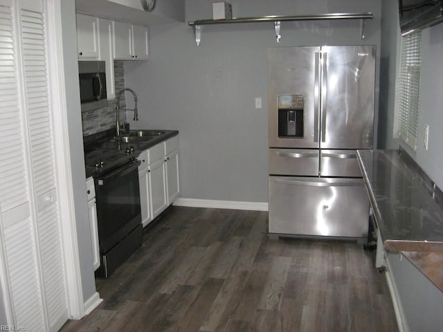 kitchen with tasteful backsplash, stainless steel appliances, white cabinets, sink, and dark hardwood / wood-style floors