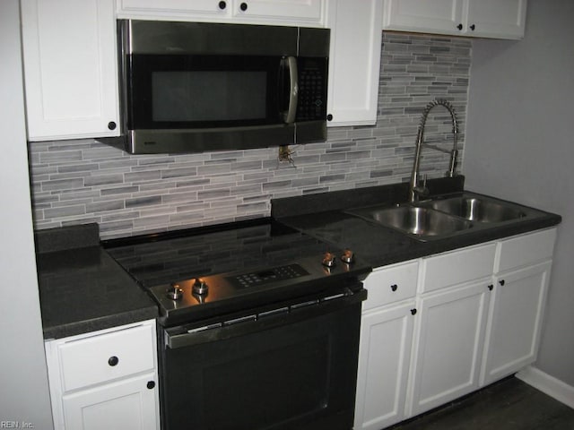 kitchen featuring sink, electric stove, tasteful backsplash, and white cabinets