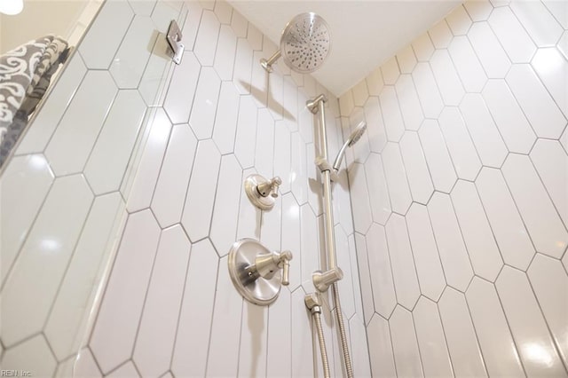 interior details featuring tiled shower