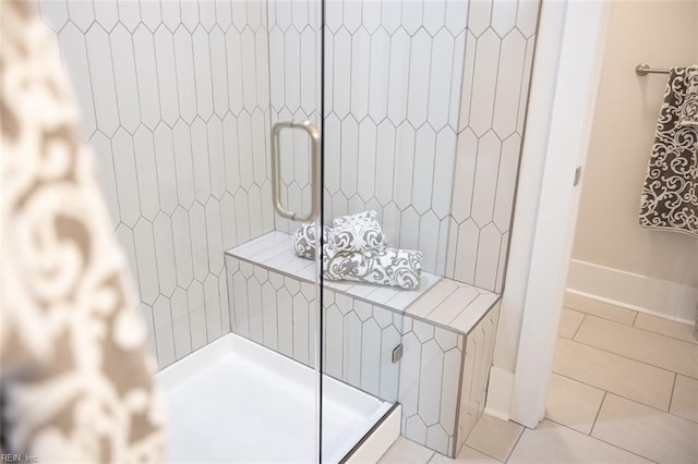 full bathroom with tile patterned flooring and a shower stall