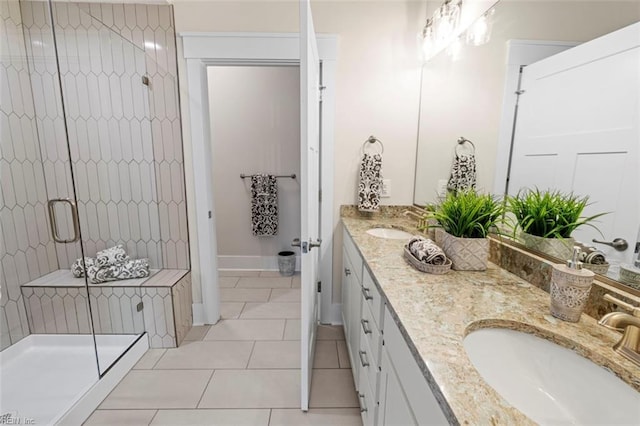 bathroom featuring dual vanity, an enclosed shower, and tile patterned floors