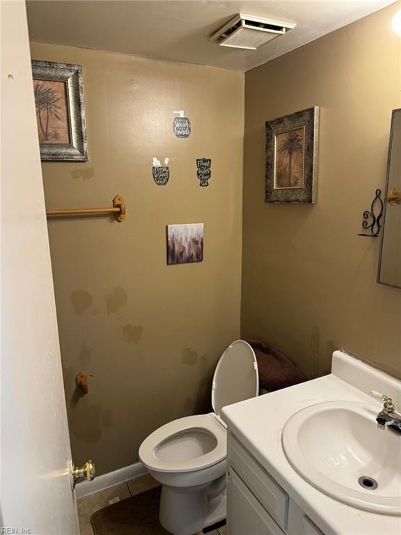 bathroom featuring vanity, tile patterned flooring, and toilet