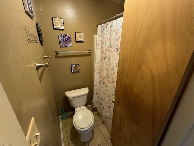 bathroom with tile patterned flooring and toilet