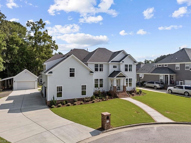 view of front of house featuring a garage, an outbuilding, and a front yard