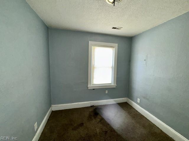 1030 37th St, Newport News, VA 23607 - carpeted spare room featuring baseboards, a textured ceiling, and visible vents
