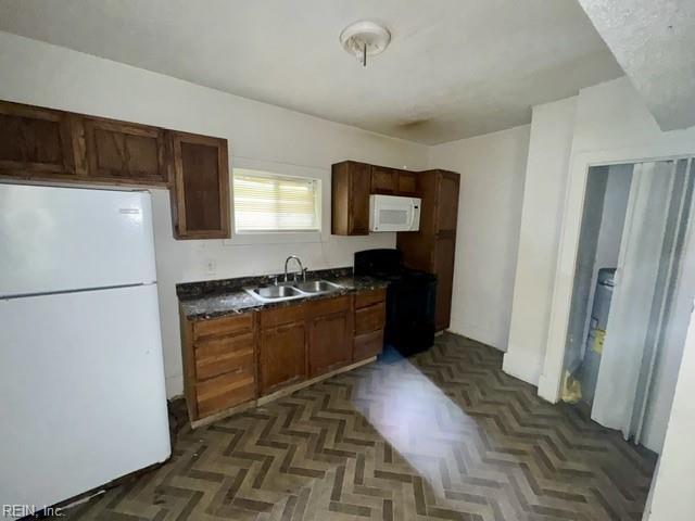 1030 37th St, Newport News, VA 23607 - kitchen with a sink, dark countertops, and white appliances