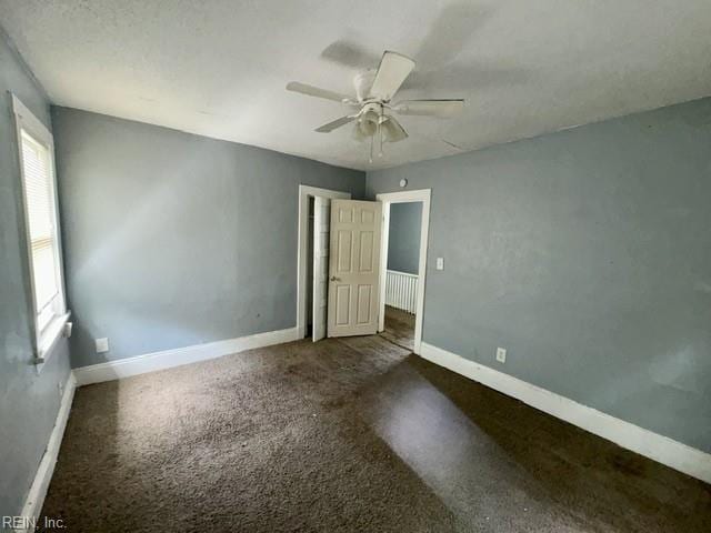 unfurnished room with baseboards and ceiling fan