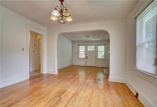 interior space featuring a notable chandelier and light wood-type flooring