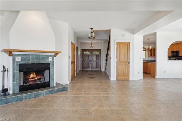 interior space with a fireplace and a chandelier