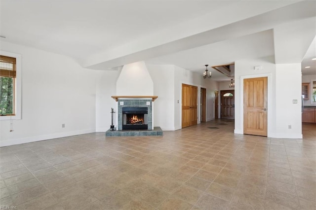 unfurnished living room featuring light tile patterned flooring and a tiled fireplace