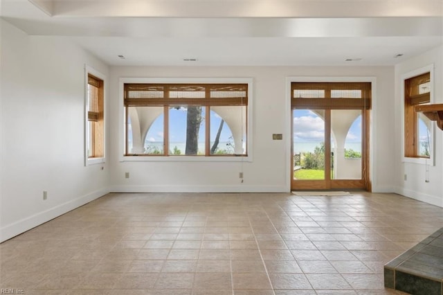 tiled spare room with plenty of natural light