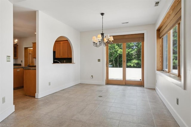 unfurnished dining area with light tile patterned flooring and an inviting chandelier