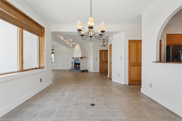 interior space featuring an inviting chandelier and light tile patterned floors