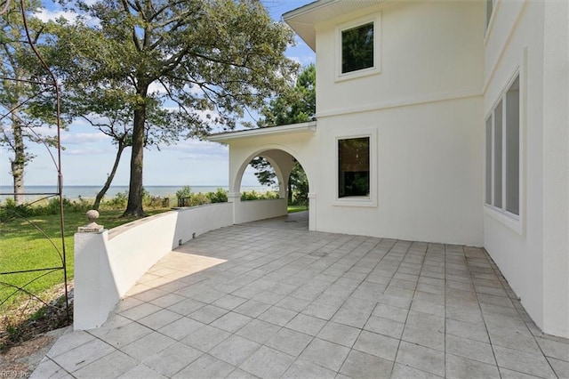 view of patio with a water view