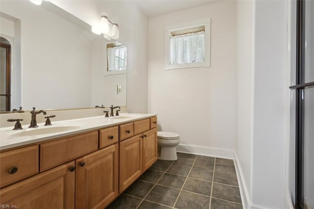 188 Tranquility Rd, Reedville, VA 22539 - bathroom featuring tile patterned flooring, toilet, baseboards, and a sink