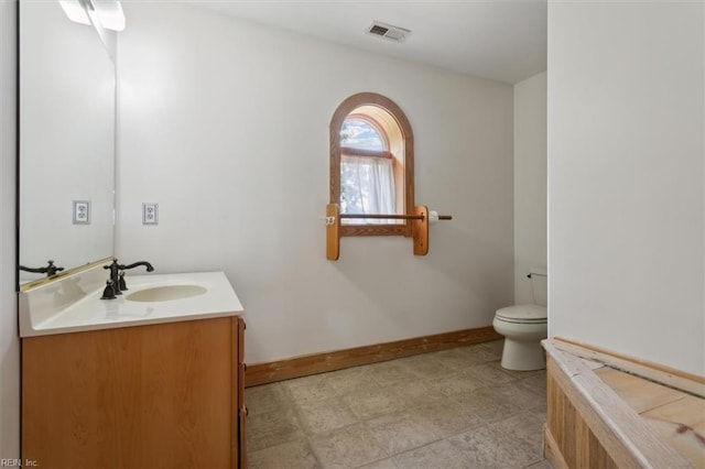 bathroom with vanity, tile patterned flooring, and toilet