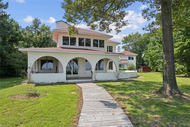 mediterranean / spanish house with a front lawn