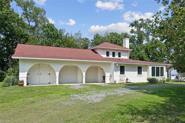 mediterranean / spanish-style house with a front yard