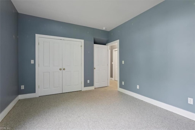 unfurnished bedroom with light carpet and a closet