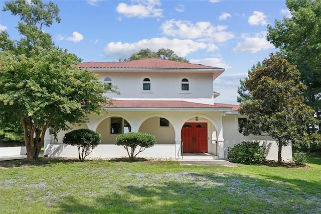 mediterranean / spanish-style home with a front lawn