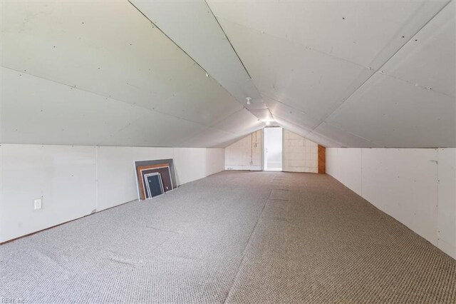 additional living space with lofted ceiling and carpet floors