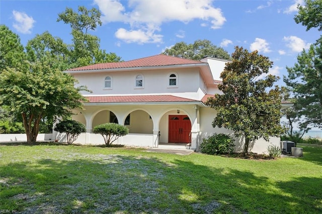 188 Tranquility Rd, Reedville, VA 22539 - mediterranean / spanish home featuring stucco siding, a front lawn, a porch, and metal roof