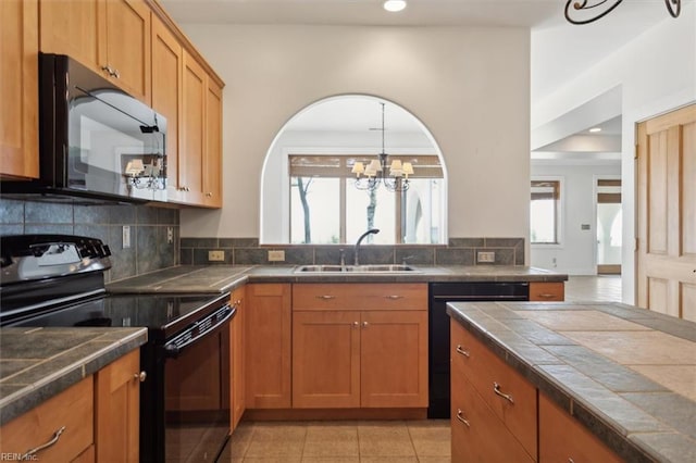 kitchen with tile counters, light tile patterned floors, black range with electric cooktop, decorative backsplash, and sink