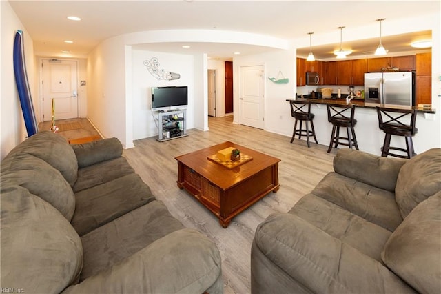 living area with recessed lighting and light wood finished floors