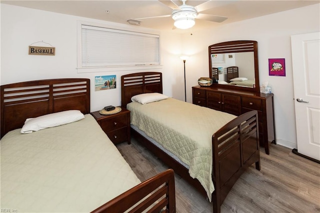 bedroom with ceiling fan and wood finished floors