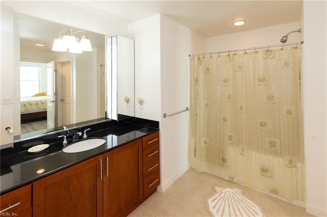 bathroom featuring tile patterned flooring, connected bathroom, vanity, shower / bath combination with curtain, and an inviting chandelier