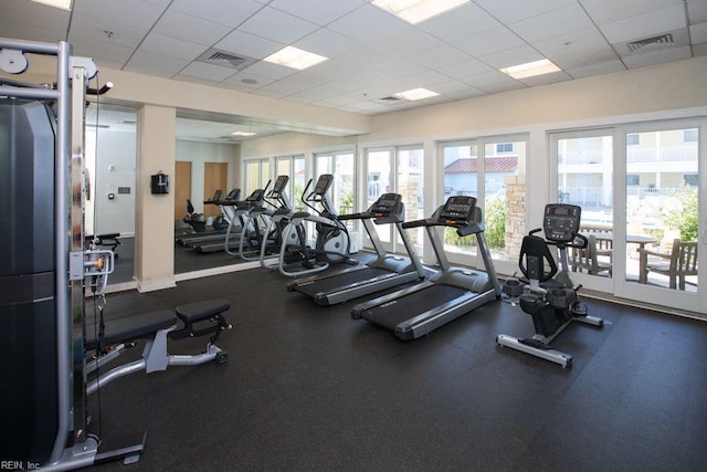 exercise room featuring visible vents and a drop ceiling