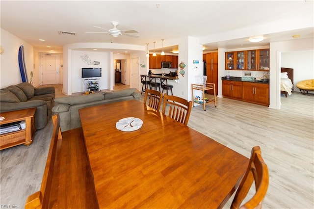 dining room with visible vents, a ceiling fan, and light wood-style floors