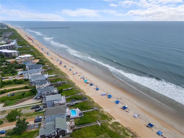 bird's eye view with a water view and a beach view