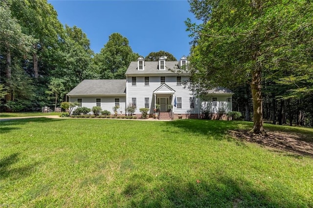 rear view of house featuring a lawn