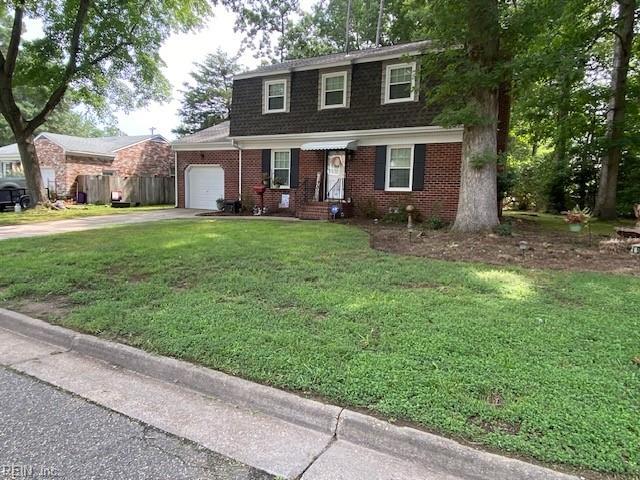 view of front of home with a garage and a front lawn