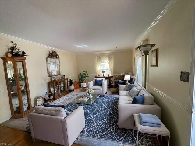 sitting room with ornamental molding and carpet