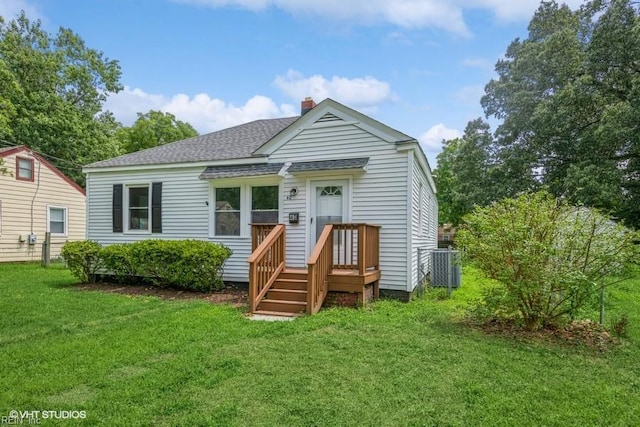 view of front of house featuring central AC and a front lawn