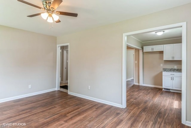 unfurnished room with dark hardwood / wood-style floors and ceiling fan