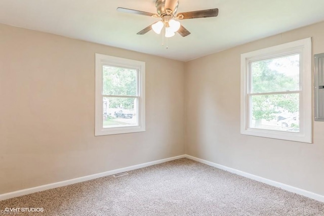 carpeted spare room featuring ceiling fan